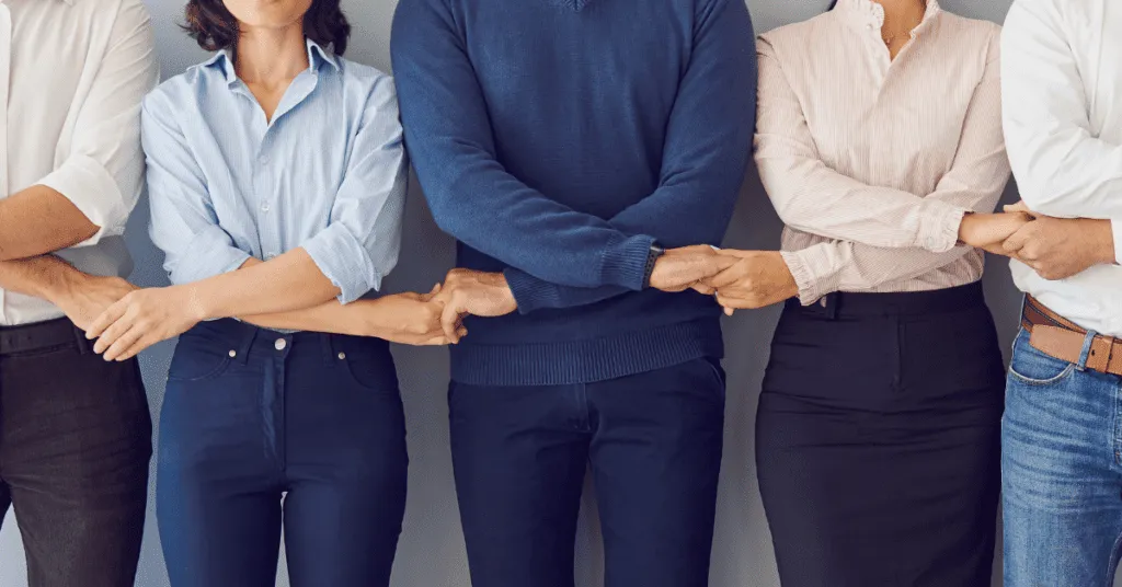 Group of people holding hands for company culture