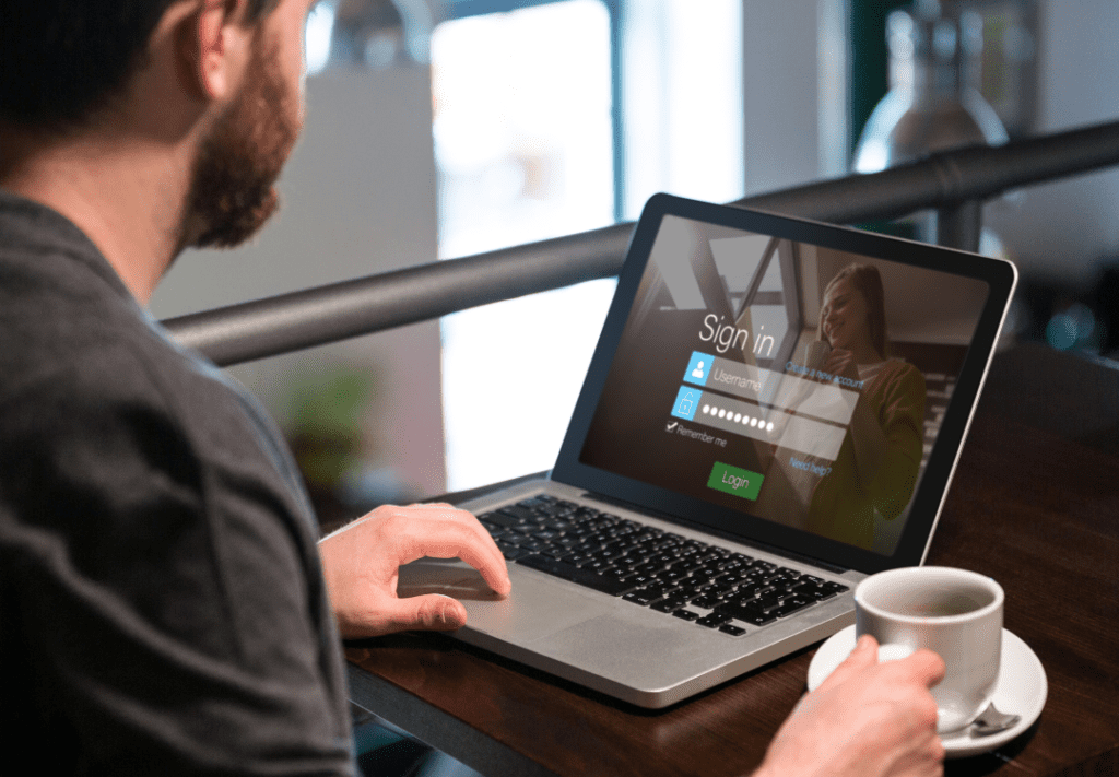 Virtual Sales Kickoff Login Page on Lpptop With Man and Coffee Cup